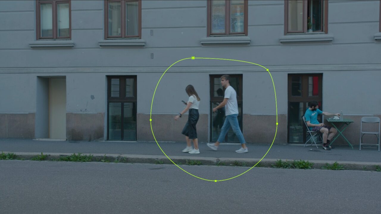 Street scene with two people walking past